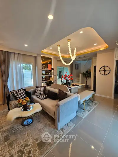 Luxurious living room with modern decor and elegant lighting, featuring plush sofas and stylish accents.