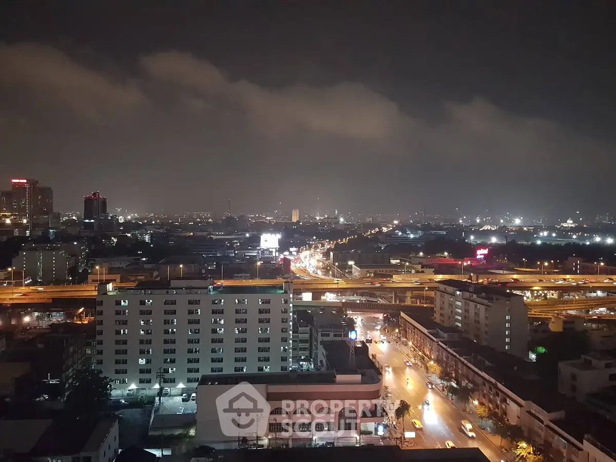 Stunning cityscape night view from high-rise building, showcasing vibrant urban lights and skyline.