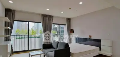 Spacious modern bedroom with balcony view in urban apartment