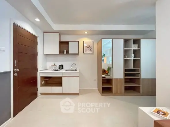 Modern open-layout kitchen with sleek cabinetry and integrated storage solutions.