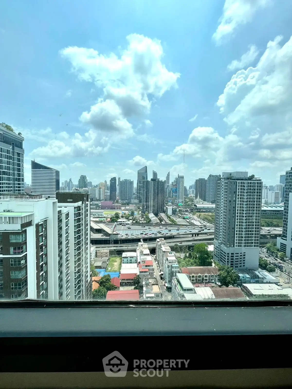 Stunning cityscape view from a high-rise building window showcasing urban skyline.