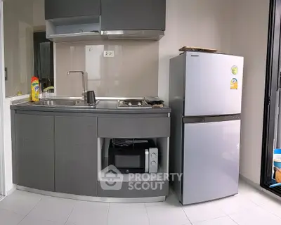 Modern compact kitchen with sleek cabinetry and stainless steel appliances