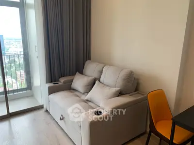 Modern living room with cozy sofa and balcony view in a stylish apartment.