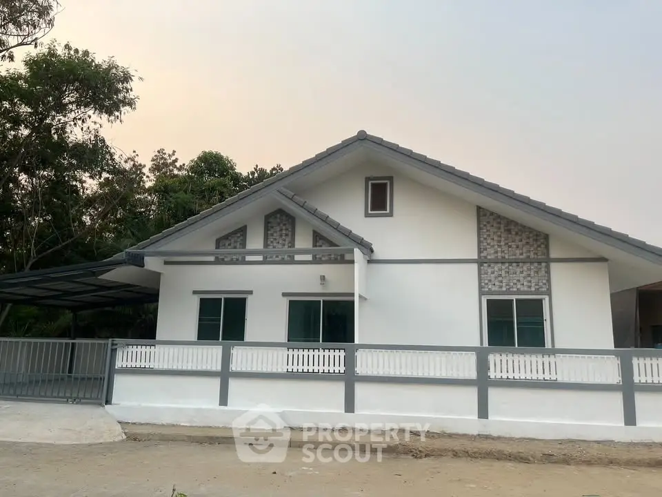 Charming single-story house with modern design and spacious outdoor area, perfect for family living.