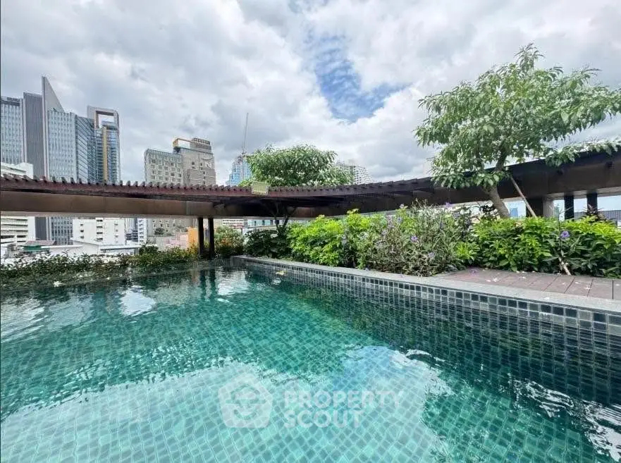 Stunning rooftop pool with city skyline views and lush greenery