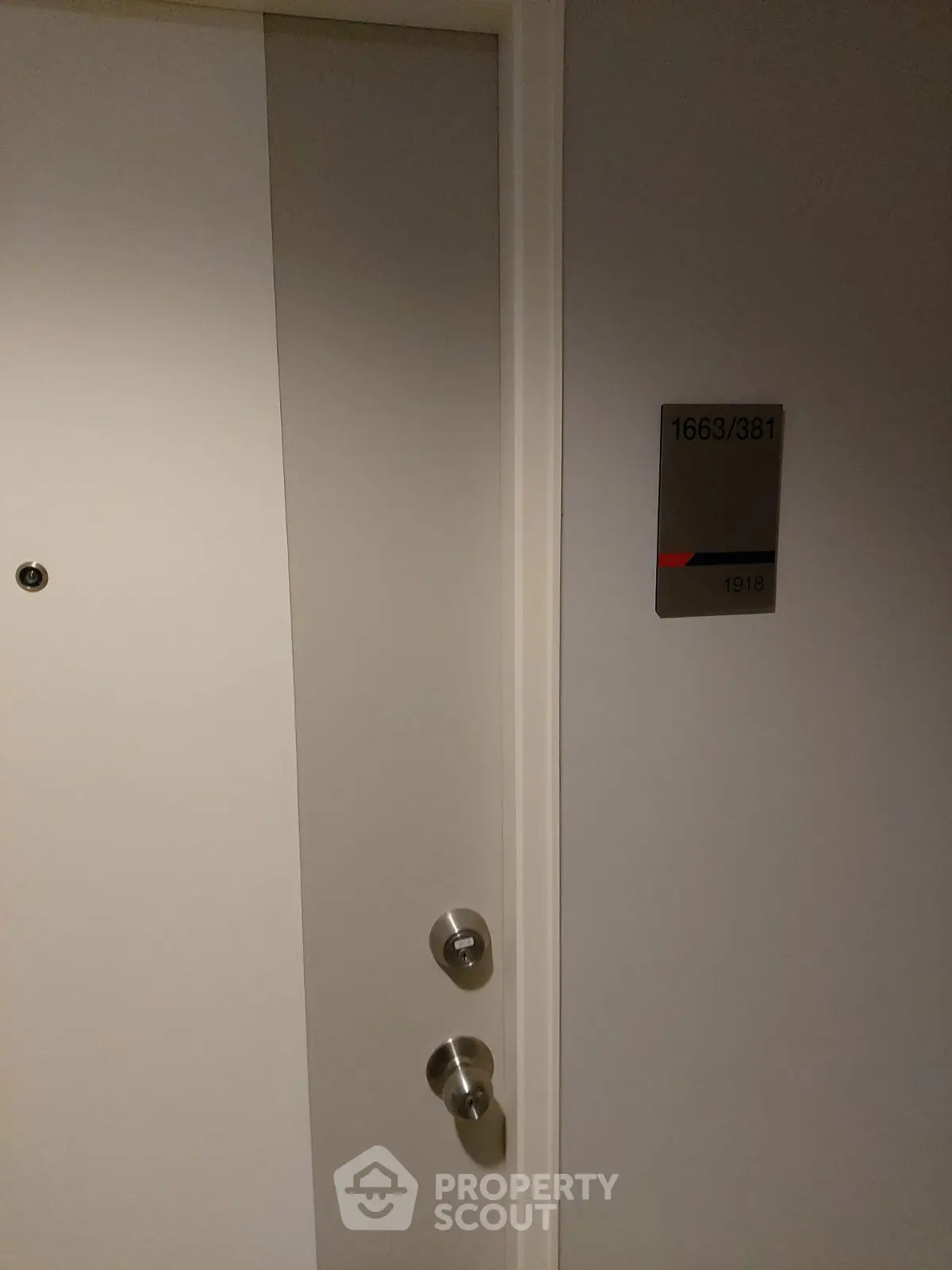Modern apartment entrance with sleek door and room number signage