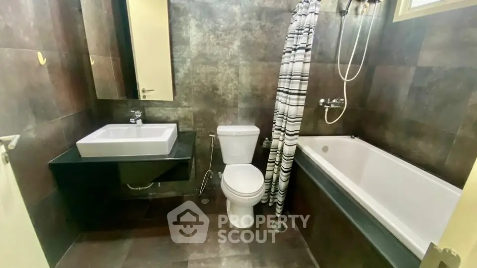 Modern bathroom with sleek fixtures and bathtub in contemporary apartment.