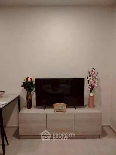 Modern living room with sleek TV stand and elegant floral decor