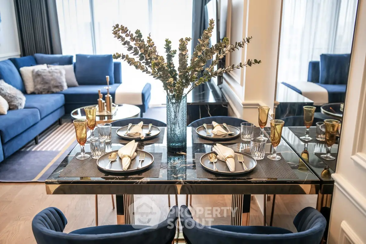 Luxurious modern living room with elegant dining setup and plush blue sofas