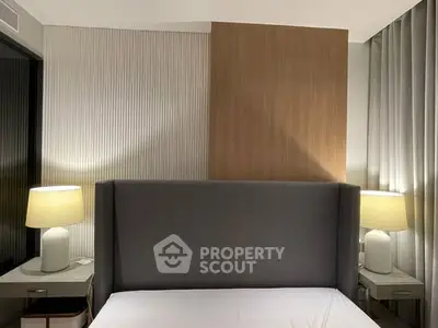 Modern bedroom with stylish headboard and elegant bedside lamps