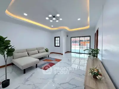 Modern living room with elegant lighting and stylish furniture, featuring a cozy sofa and decorative plants.
