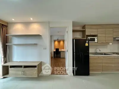 Modern open-plan kitchen with sleek wooden cabinetry and spacious living area.