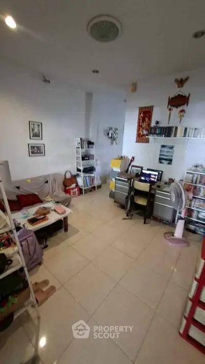 Spacious study room with modern decor and ample storage space, perfect for productivity and relaxation.