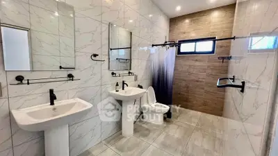 Modern bathroom with dual sinks, elegant fixtures, and stylish tile design.