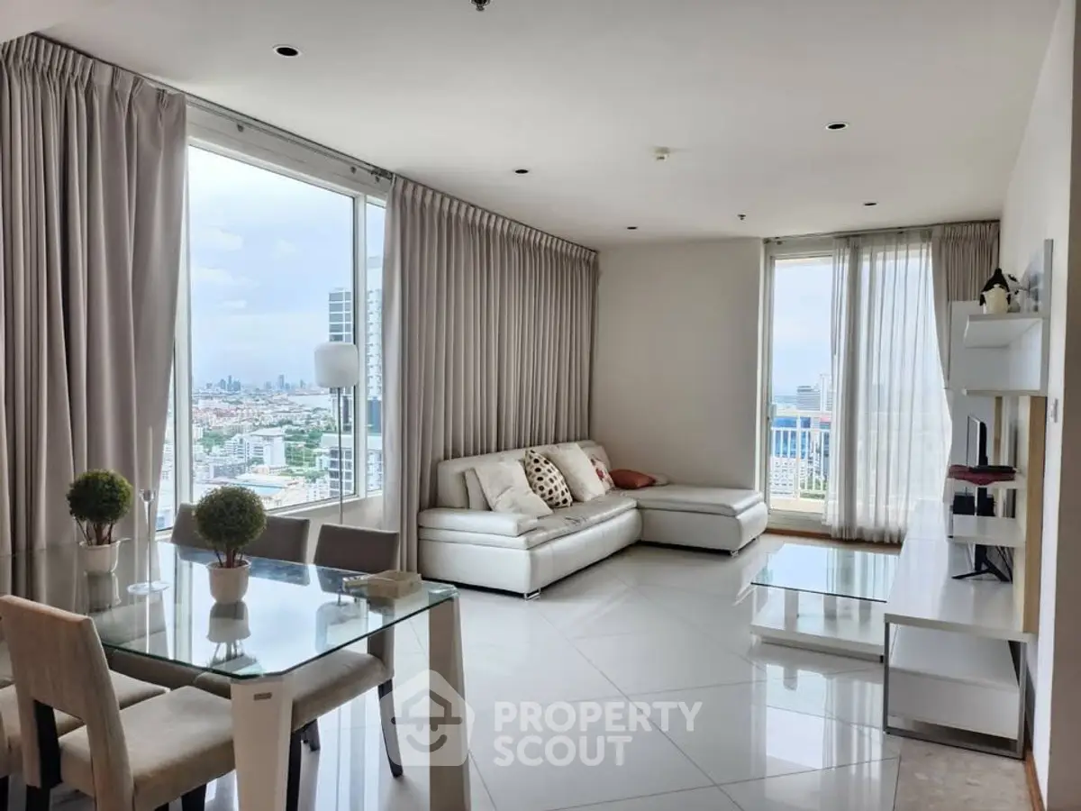 Spacious modern living room with panoramic city views and elegant decor.