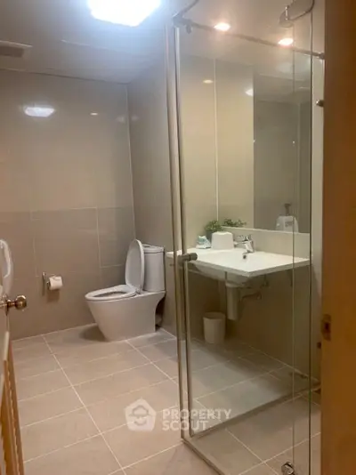 Modern bathroom with glass shower and sleek fixtures