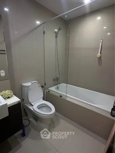 Modern bathroom with sleek design featuring bathtub and shower combo