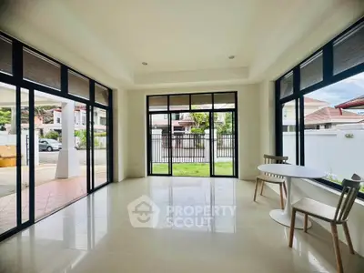 Spacious modern living room with large windows and garden view