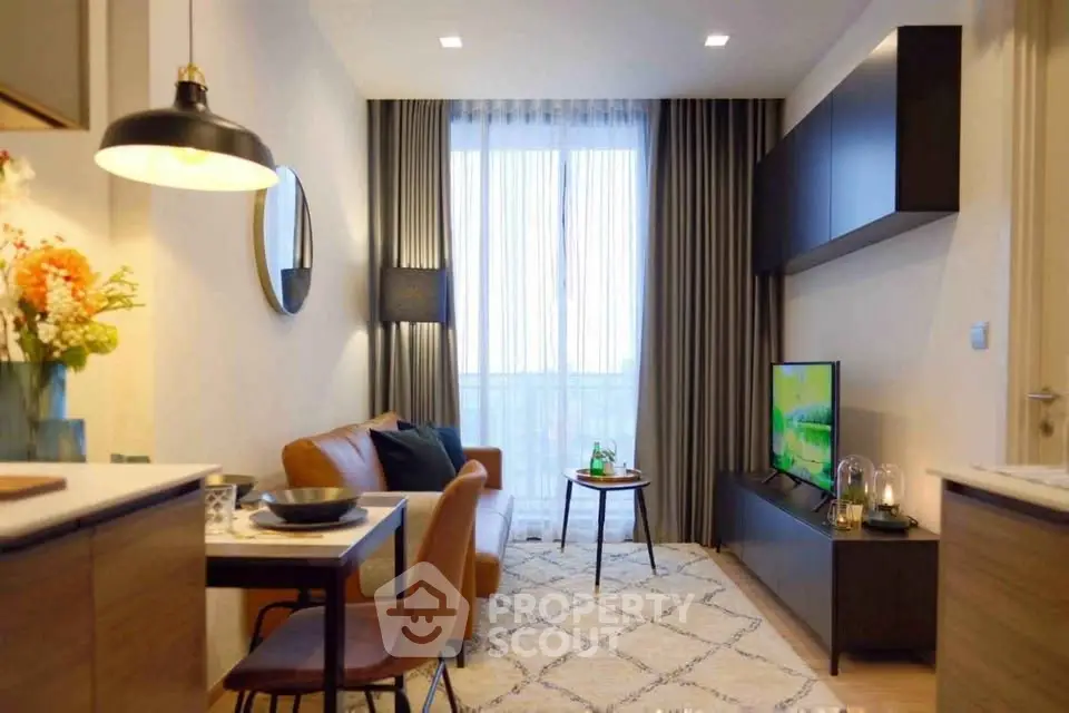 Modern living room with stylish decor, cozy seating, and natural light from large window.