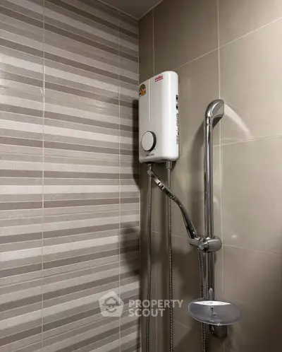 Modern bathroom with sleek shower unit and stylish tile design.