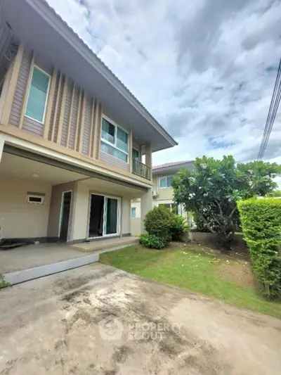 Modern two-story house with lush garden and spacious driveway
