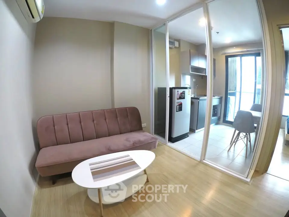 Modern living room with glass partition and cozy kitchen area