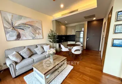 Modern living room with cozy seating and stylish decor in open layout apartment.