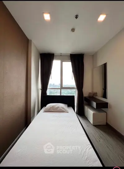 Modern minimalist bedroom with large window and sleek furnishings