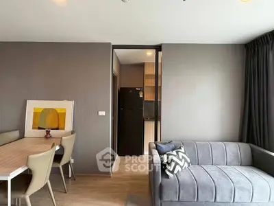 Modern living room with stylish furniture and open kitchen layout in a cozy apartment.