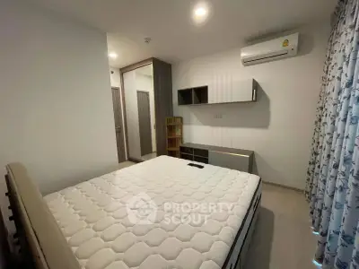 Modern bedroom with air conditioning and stylish furnishings in a cozy apartment.