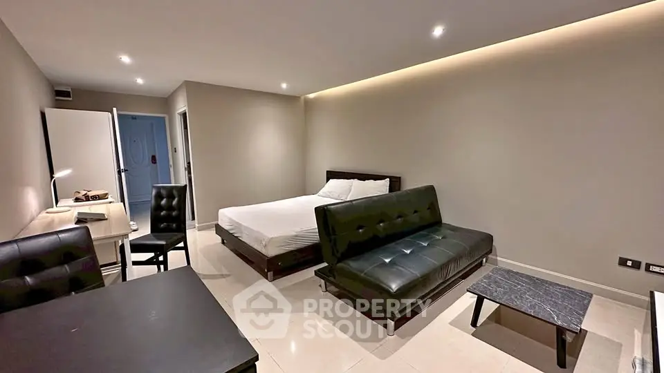 Modern studio apartment with sleek furniture and ambient lighting