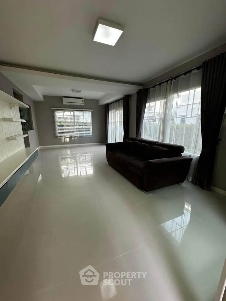 Spacious living room with modern design and large windows for natural light.