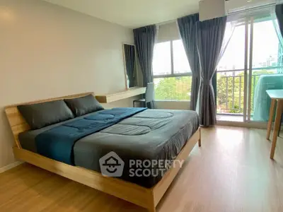 Spacious bedroom with modern decor and large windows offering a scenic view, perfect for relaxation.
