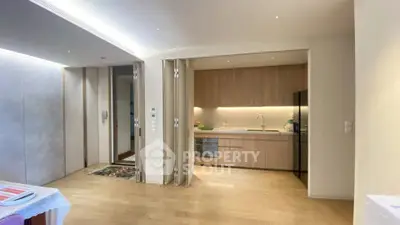 Modern open kitchen with sleek cabinetry and integrated appliances in a stylish apartment.