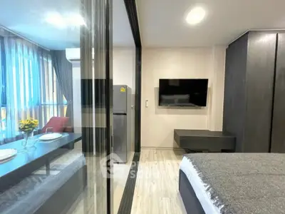 Modern studio apartment with sleek design and large windows for natural light.