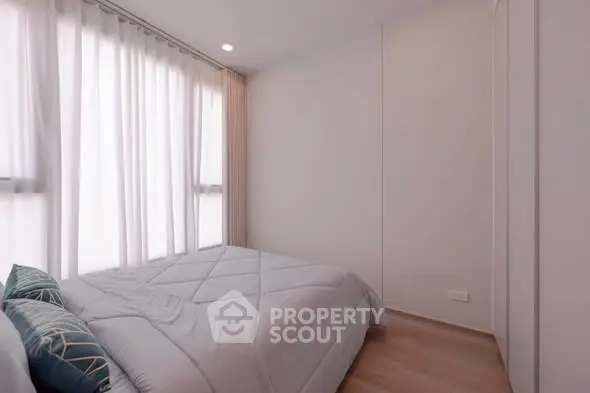 Cozy bedroom with soft lighting and modern decor, perfect for relaxation.