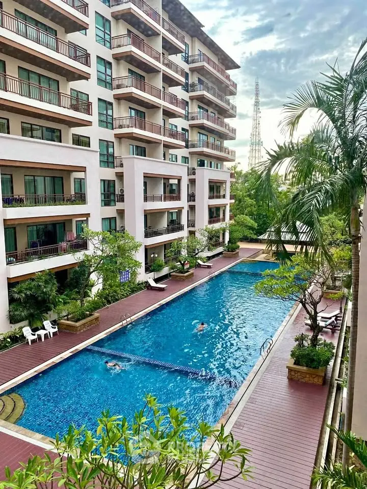 Luxurious apartment building with inviting outdoor pool and lush greenery.
