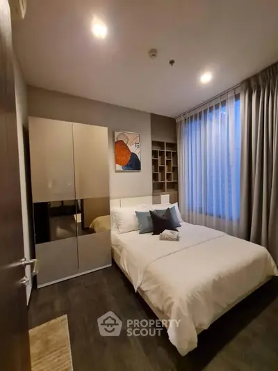 Modern bedroom with stylish decor and ample natural light