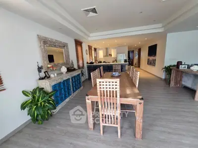Spacious open-plan living and dining area with modern decor and wooden furniture.