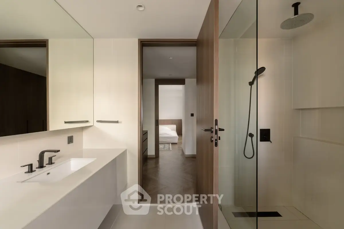 Modern bathroom with sleek fixtures and glass shower in luxury apartment