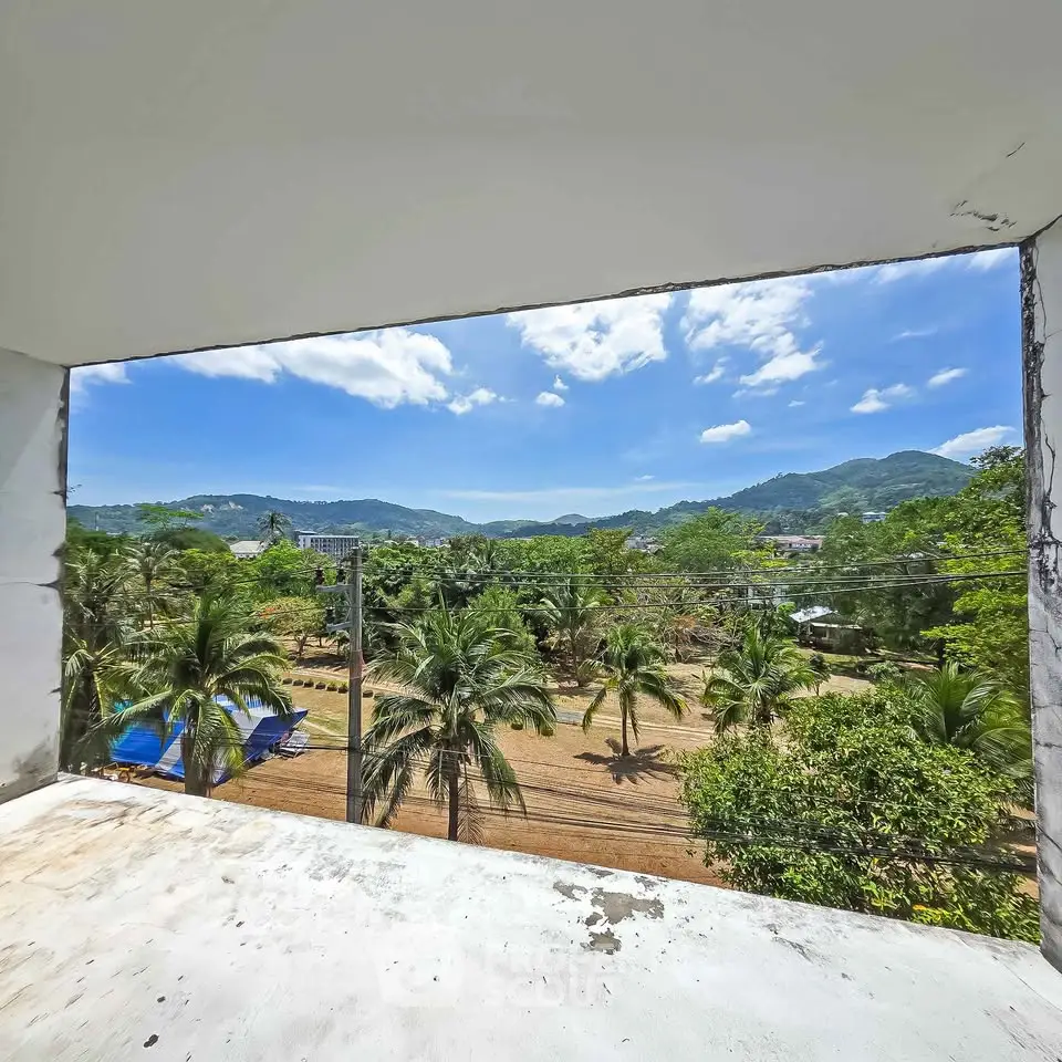 Stunning tropical view from a balcony overlooking lush greenery and mountains.