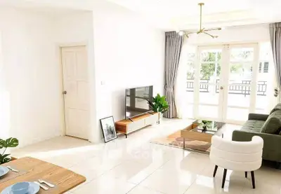 Bright and spacious living room with modern decor and large windows