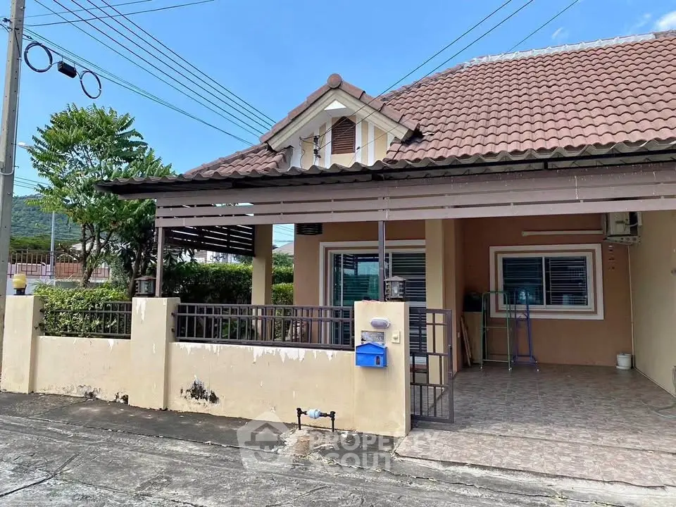 Charming single-story home with tiled roof and spacious front patio, perfect for family living.