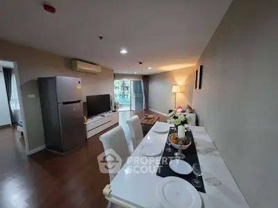 Spacious modern living room with dining area and large windows in a stylish apartment.