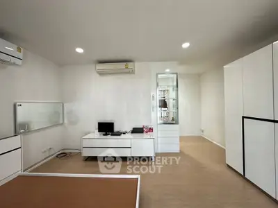 Modern living room with sleek furniture and air conditioning