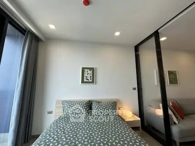 Modern bedroom with stylish decor and large mirror closet