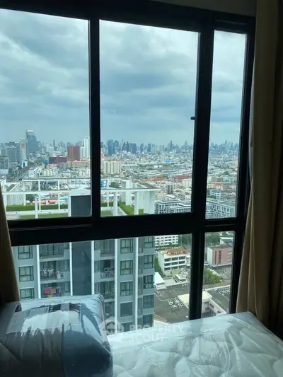Stunning cityscape view from high-rise apartment window, showcasing urban skyline and modern living.