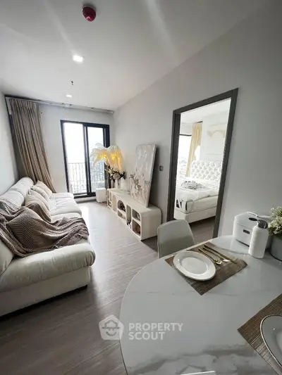Modern living room with elegant decor and cozy bedroom view