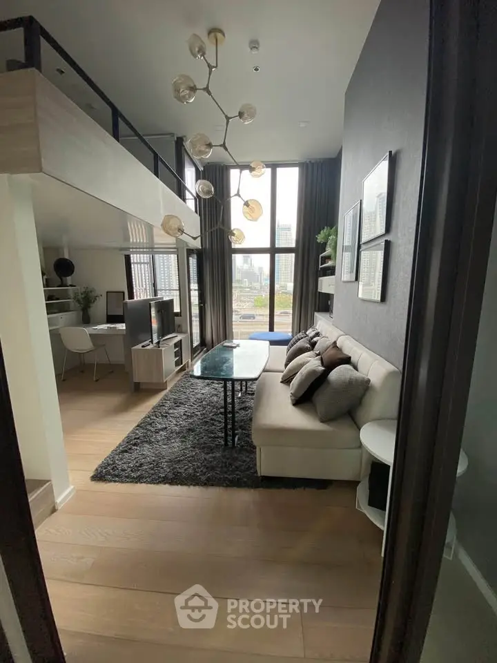 Modern loft-style living room with high ceilings and city view, featuring chic decor and cozy seating area.