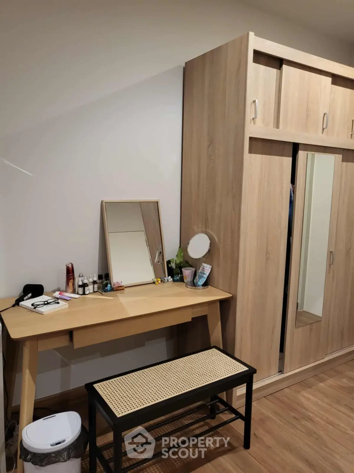 Cozy bedroom with wooden wardrobe and dressing table, perfect for modern living.